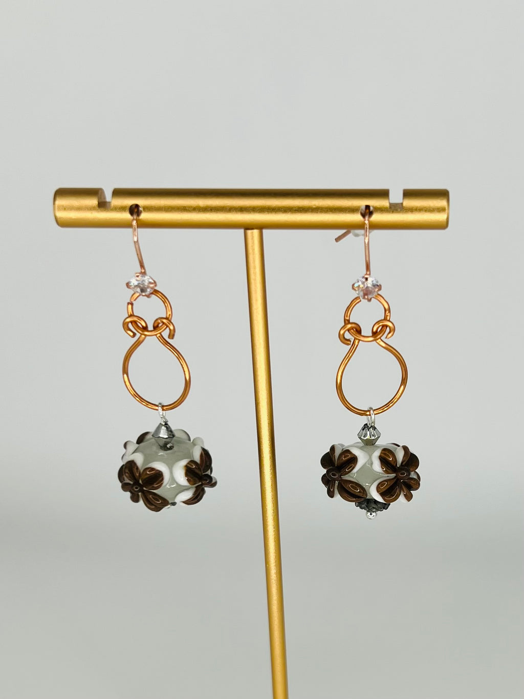 Hand-Shaped Copper Wire Earrings with Brown and White Floral Bead