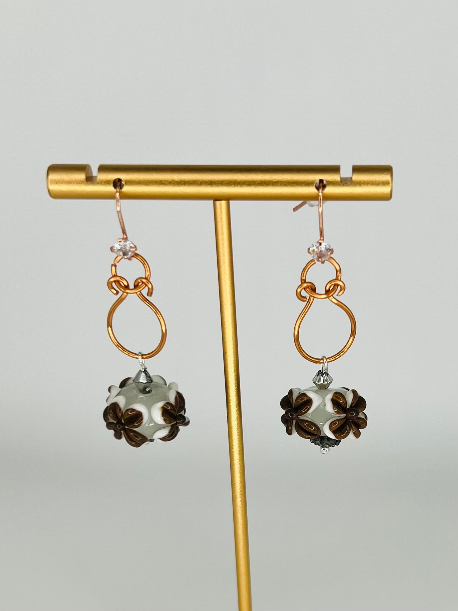 Hand-Shaped Copper Wire Earrings with Brown and White Floral Bead